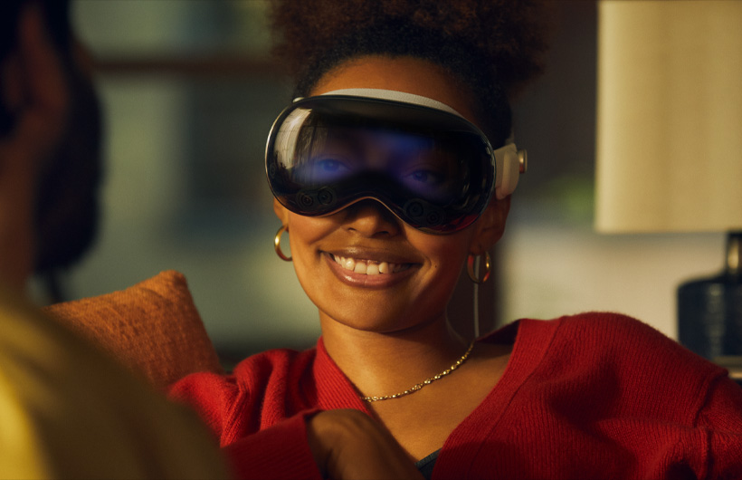 EyeSight revealing a person's eyes on the front of Apple Vision Pro as someone approaches