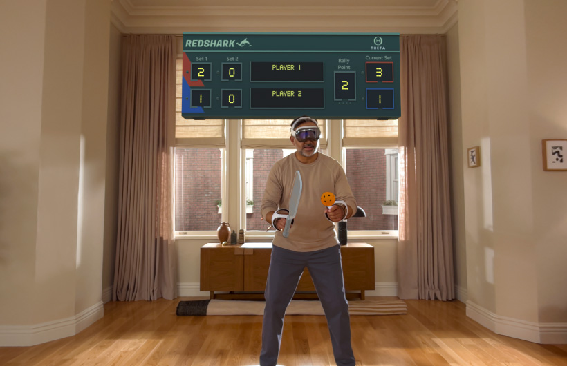 A person playing a game using Apple Vision Pro and a PlayStation VR2 Sense controller